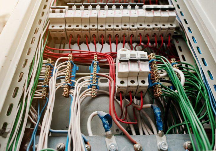 Close up view of electrical panel with fuses and contactors.